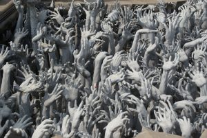 At the entrance; multitude of hands coming from the underworld... What Rong Thailand