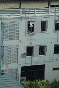 man balancing on a ladder