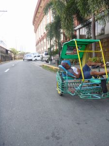 Tuk-Tuk driver patiently waiting for some custom.