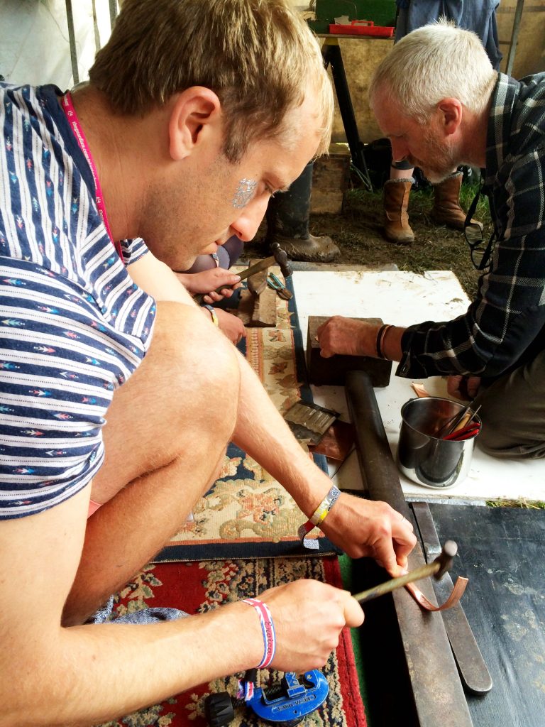 Olly makes a copper bracelet